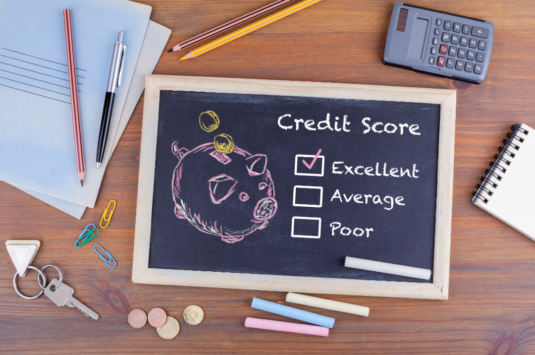 Blackboard with a pink pig drawn on it and the words Credit score, Excellent, Average and Poor